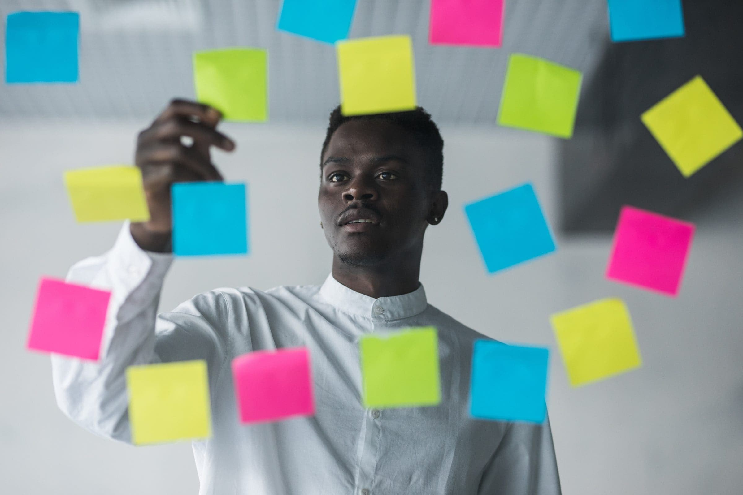 A strategist mapping ideas on a glass wall